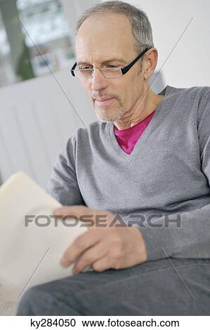 Man reading a book View Large Photo Image Stock Image - Man reading a book. Fotosearch