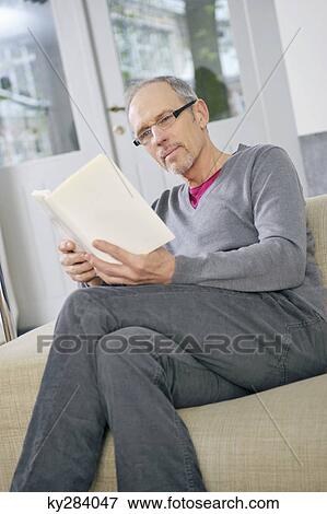 Stock Photo - Man reading a book. Fotosearch