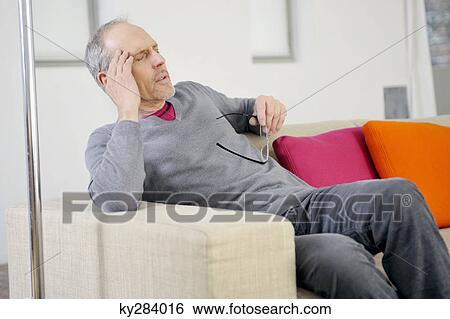 Man suffering from a headache View Large Photo Image Stock Photograph - Man suffering from a headache. Fotosearch