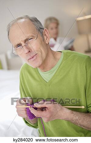 Portrait of a man knitting with a woman in the background View Large Photo Image Stock Image - Portrait of a man knitting with a woman in the background. Fotosearch