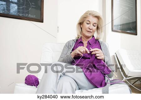 Stock Image - Woman knitting. Fotosearch
