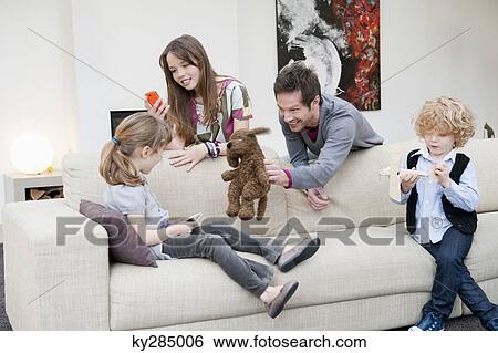 Family in a living room View Large Photo Image Stock Photograph - Family in a living room. Fotosearch