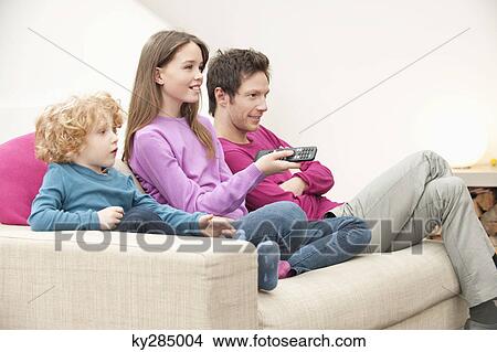 Family watching television View Large Photo Image Picture - Family watching television. Fotosearch