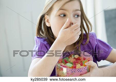 Stock Photo - Girl holding a box full of gum drops. Fotosearch