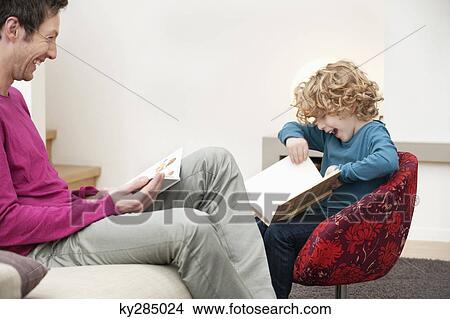 Man and his son reading books View Large Photo Image Picture - Man and his son reading books. Fotosearch
