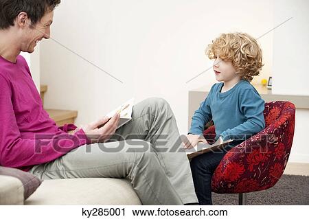 Man and his son reading books View Large Photo Image Stock Image - Man and his son reading books. Fotosearch
