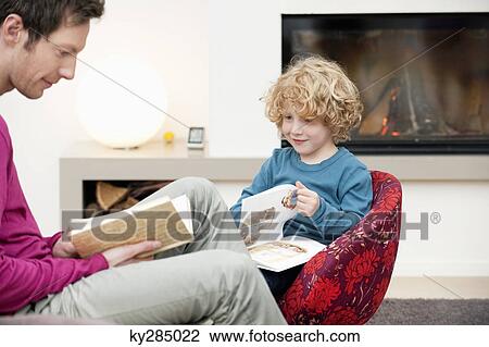 Man and his son reading books View Large Photo Image Stock Image - Man and his son reading books. Fotosearch