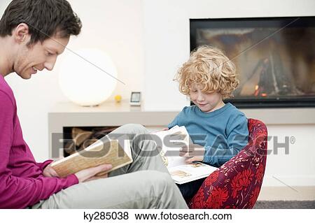 Man and his son reading books View Large Photo Image Stock Photo - Man and his son reading books. Fotosearch