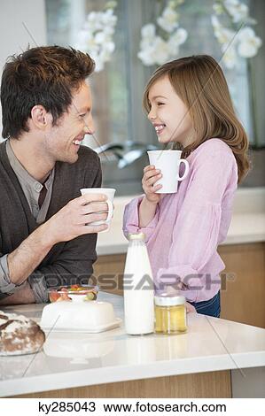 Man drinking coffee with his daughter View Large Photo Image Stock Image - Man drinking coffee with his daughter. Fotosearch