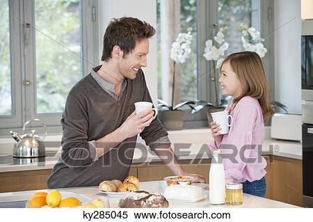 Man drinking coffee with his daughter View Large Photo Image Stock Photography - Man drinking coffee with his daughter. Fotosearch