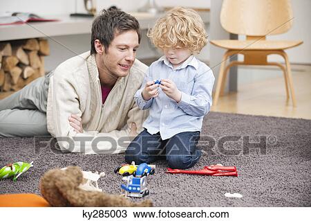 Man playing with his son View Large Photo Image Stock Image - Man playing with his son. Fotosearch