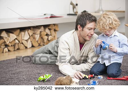 Stock Image - Man playing with his son. Fotosearch