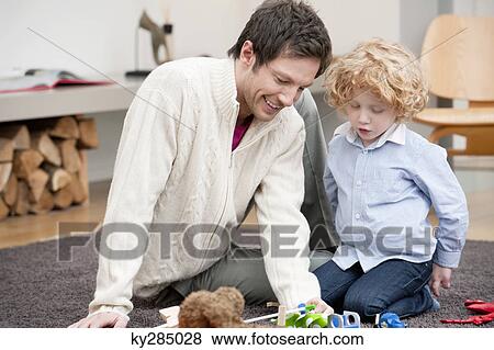 Stock Photo - Man playing with his son. Fotosearch