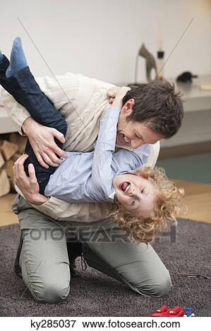 Man playing with his son View Large Photo Image Stock Photo - Man playing with his son. Fotosearch