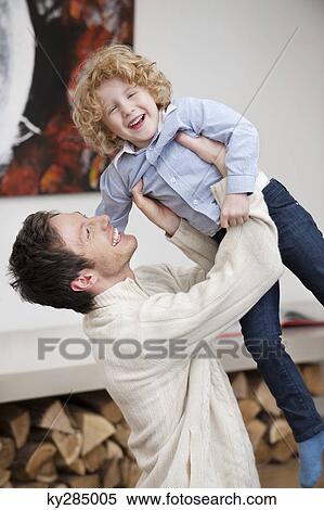 Man playing with his son View Large Photo Image Stock Photography - Man playing with his son. Fotosearch