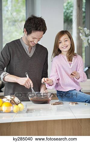 Man stirring a mixture in a bowl with his daughter View Large Photo Image Stock Image - Man stirring a mixture in a bowl with his daughter. Fotosearch