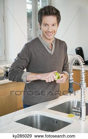 Portrait of a man working in the kitchen View Large Photo Image Stock Photo - Portrait of a man working in the kitchen. Fotosearch