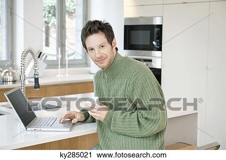 Portrait of a man working on a laptop View Large Photo Image Stock Image - Portrait of a man working on a laptop. Fotosearch