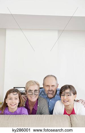 Couple smiling with their granddaughters View Large Photo Image Stock Image - Couple smiling with their granddaughters. Fotosearch
