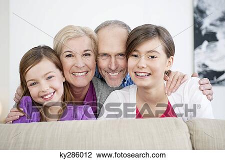 Couple smiling with their granddaughters View Large Photo Image Stock Image - Couple smiling with their granddaughters. Fotosearch