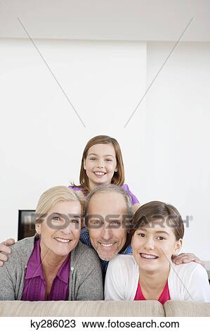 Couple smiling with their granddaughters View Large Photo Image Stock Image - Couple smiling with their granddaughters. Fotosearch