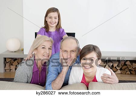 Couple smiling with their granddaughters View Large Photo Image Stock Photo - Couple smiling with their granddaughters. Fotosearch