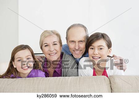 Couple smiling with their granddaughters View Large Photo Image Stock Photo - Couple smiling with their granddaughters. Fotosearch