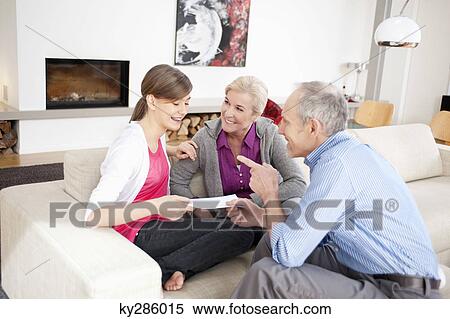 Stock Photography - Girl sitting with her grandparents. Fotosearch