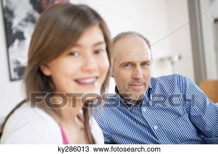 Girl smiling with her grandfather View Large Photo Image Stock Image - Girl smiling with her grandfather. Fotosearch