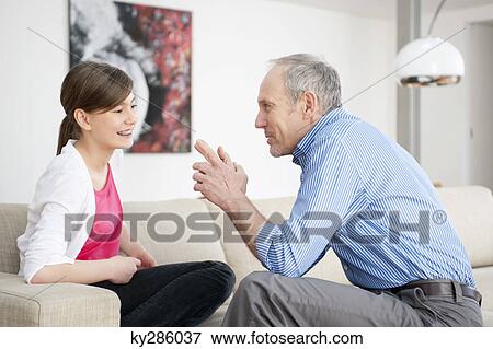 Girl smiling with her grandfather View Large Photo Image Stock Photo - Girl smiling with her grandfather. Fotosearch