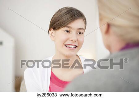 Girl smiling with her grandmother View Large Photo Image Stock Image - Girl smiling with her grandmother. Fotosearch