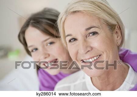 Picture - Portrait of a girl hugging her grandmother. Fotosearch