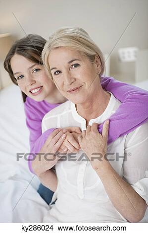 Portrait of a girl hugging her grandmother View Large Photo Image Picture - Portrait of a girl hugging her grandmother. Fotosearch