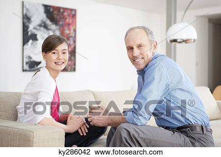 Portrait of a girl smiling with her grandfather View Large Photo Image Stock Image - Portrait of a girl smiling with her grandfather. Fotosearch