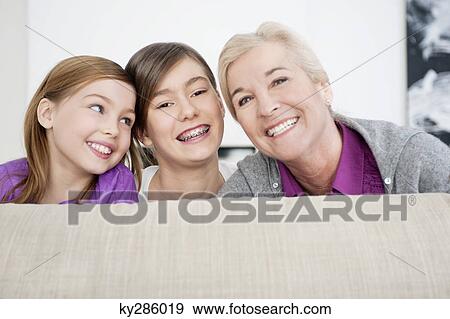 Portrait of a woman smiling with her granddaughters View Large Photo Image Stock Photo - Portrait of a woman smiling with her granddaughters. Fotosearch