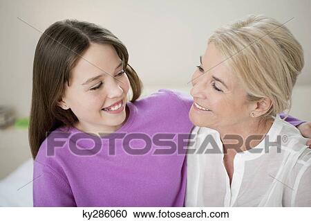 Woman smiling with her granddaughter View Large Photo Image Stock Image - Woman smiling with her granddaughter. Fotosearch