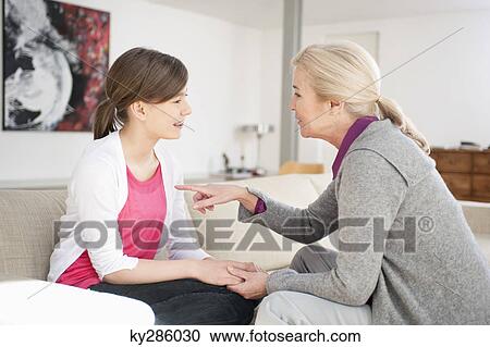 Stock Image - Woman talking with her granddaughter. Fotosearch