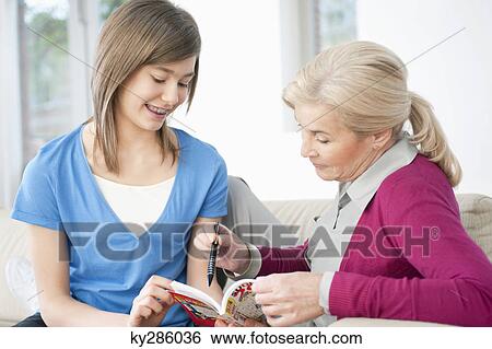 Woman teaching her granddaughter View Large Photo Image Stock Photograph - Woman teaching her granddaughter. Fotosearch