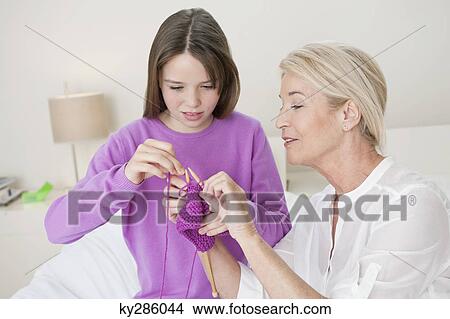 Woman teaching her granddaughter to knit View Large Photo Image Picture - Woman teaching her granddaughter to knit. Fotosearch