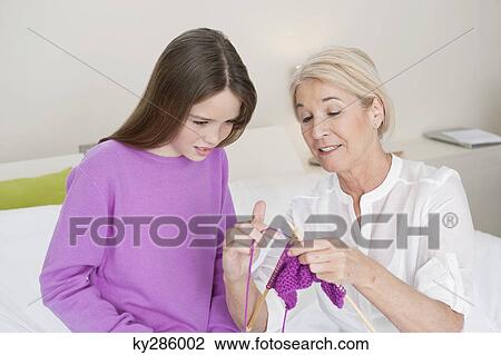 Woman teaching her granddaughter to knit View Large Photo Image Stock Image - Woman teaching her granddaughter to knit. Fotosearch