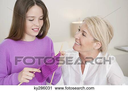 Woman teaching her granddaughter to knit View Large Photo Image Stock Image - Woman teaching her granddaughter to knit. Fotosearch