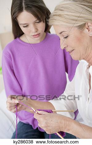 Woman teaching her granddaughter to knit View Large Photo Image Stock Photo - Woman teaching her granddaughter to knit. Fotosearch