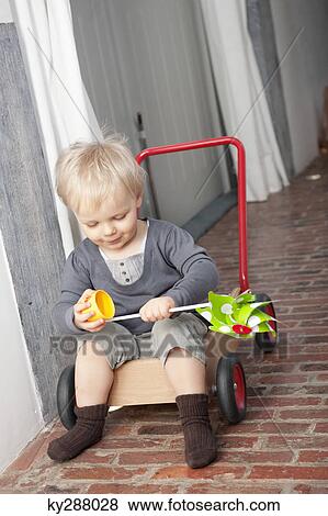 Boy playing with a pinwheel View Large Photo Image Stock Photo - Boy playing with a pinwheel. Fotosearch