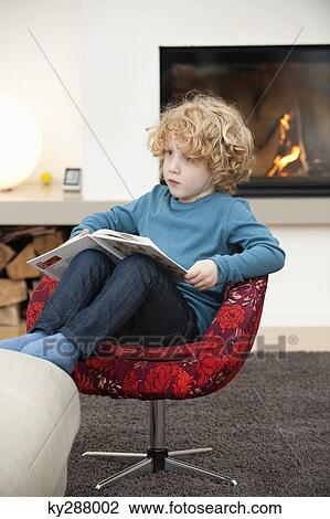 Boy reading a book View Large Photo Image Stock Image - Boy reading a book. Fotosearch