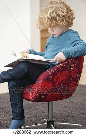 Stock Image - Boy reading a book. Fotosearch