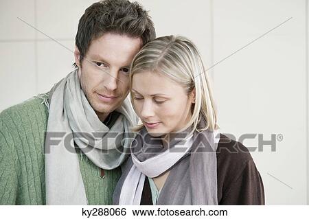 Close-up of a couple standing together View Large Photo Image Stock Photograph - Close-up of a couple standing together. Fotosearch