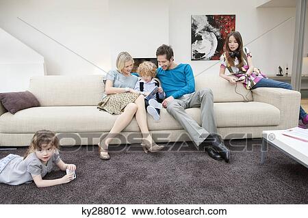 Family in a living room View Large Photo Image Stock Image - Family in a living room. Fotosearch