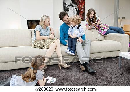 Family in a living room View Large Photo Image Stock Image - Family in a living room. Fotosearch