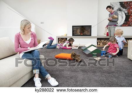 Stock Image - Family in a living room. Fotosearch