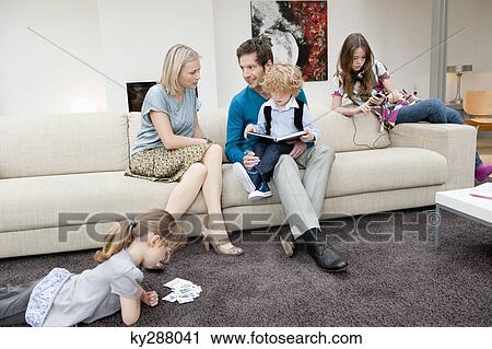 Family in a living room View Large Photo Image Stock Image - Family in a living room. Fotosearch